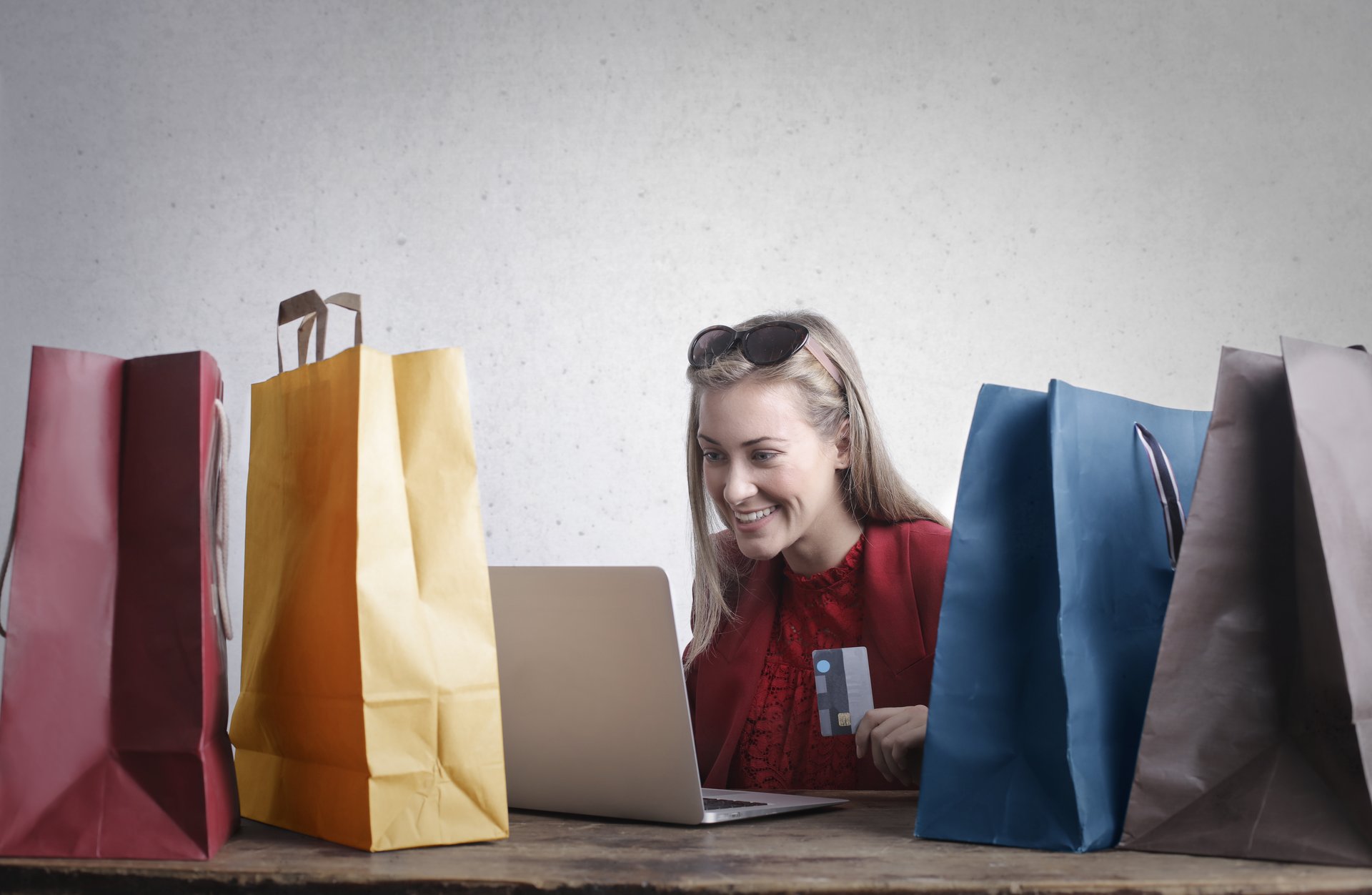 woman shopping at computer holding credit card